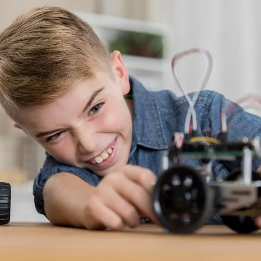 Young boy playing with an electrical device